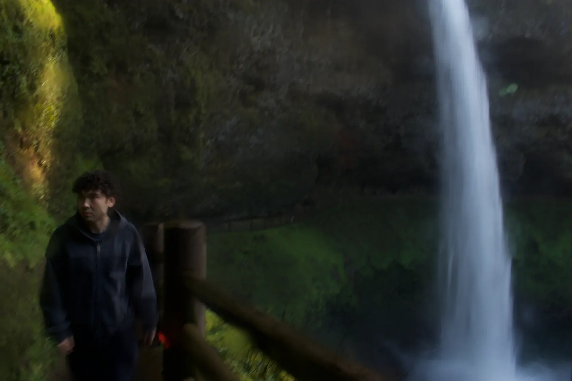 A portrait beside a waterfall