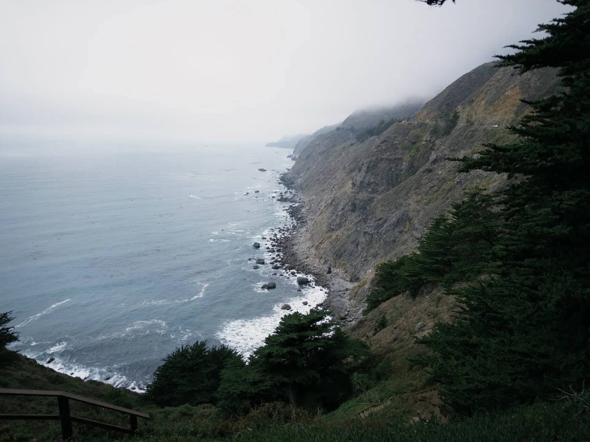 Coastal cliffs disappearing into the fog